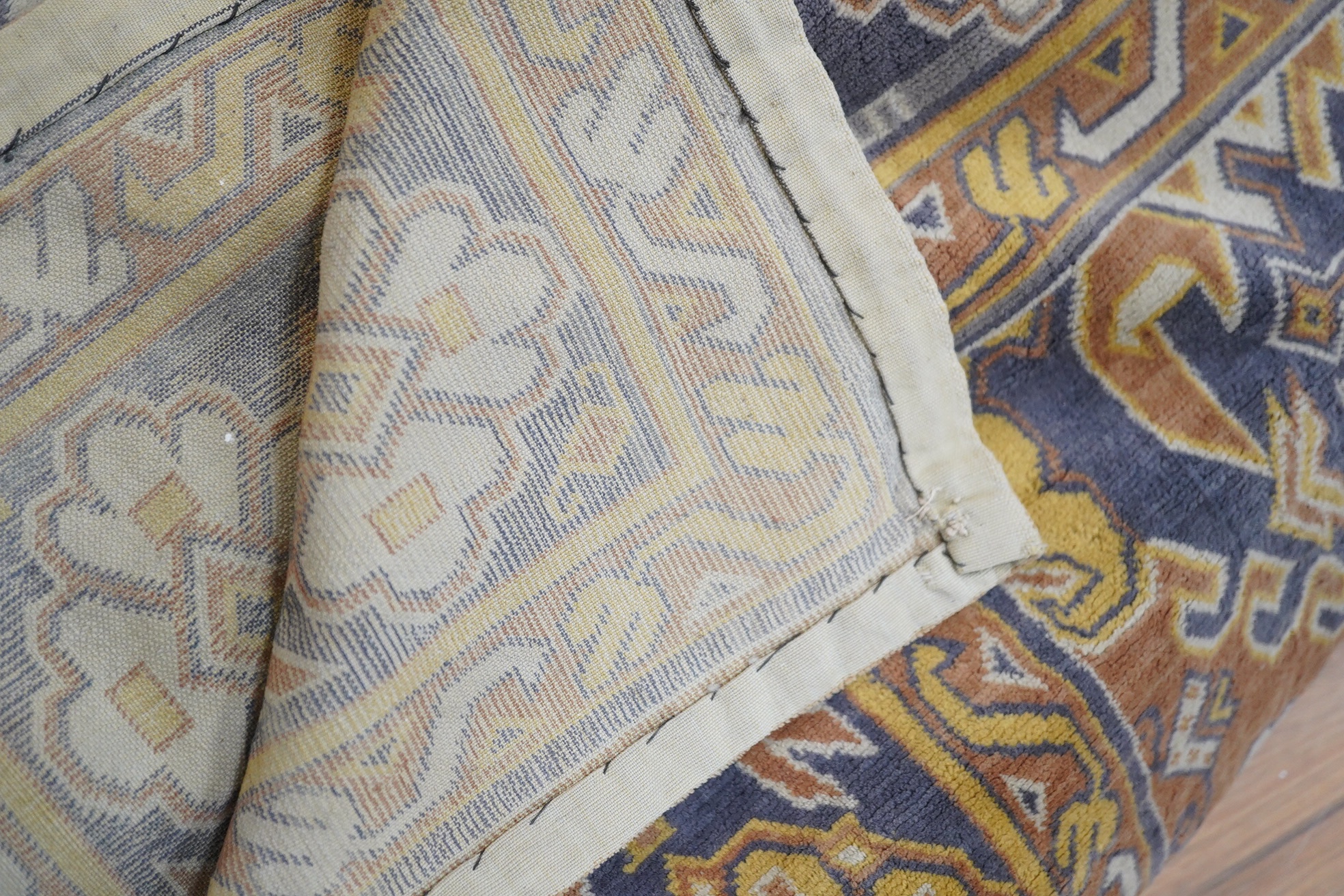 An Edwardian table cover in brightly coloured wools, with a floral design, together with a later 20th century continental grey, beige and cream patterned silk cover, Edwardian table cover 220cm x 172cm. Condition - colou